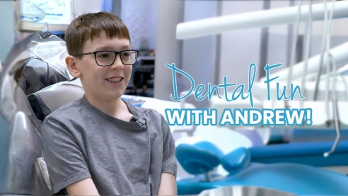 Young boy sitting in a dental chair with dental equipment in the background, smiling during a visit to an emergency dentist in Katy, TX. Text on image reads 'Dental Fun with Andrew!' indicating a positive dental experience. Keywords: Emergency Dentist, Katy TX, dental care, same-day.