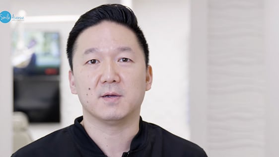 Dentist discussing patient education and smile tips in a dental office setting, representing Katy Dental Video Library.