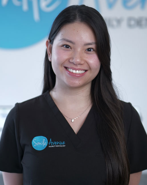Smiling female dental professional wearing a Smile Avenue Family Dentistry uniform, showcasing comprehensive family dentistry service in Cypress and Katy, TX.
